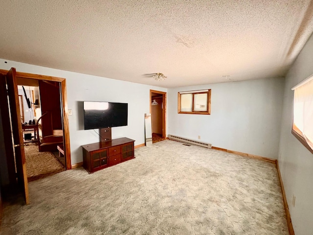 113 6th Ave SE, Baudette, MN 56623 - unfurnished living room with a baseboard heating unit, carpet floors, a textured ceiling, and baseboards