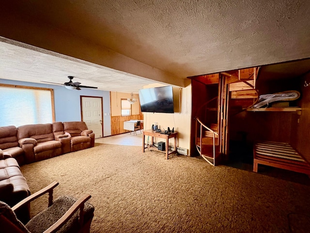 113 6th Ave SE, Baudette, MN 56623 - carpeted living room featuring a textured ceiling, wooden walls, and ceiling fan