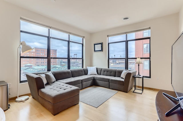 270 4th St E Unit 402, Saint Paul, MN 55101 - living room featuring light wood-style flooring, baseboards, and a city view