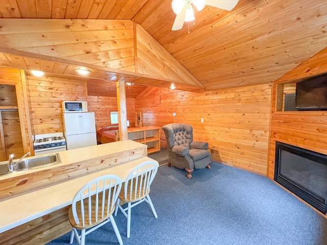 27621 83 Unit 2, Battle Lake, MN 56515 - kitchen with white appliances, wooden ceiling, vaulted ceiling, a sink, and wooden walls