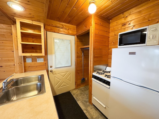 27621 83 Unit 2, Battle Lake, MN 56515 - kitchen featuring white appliances, a sink, wooden walls, wood ceiling, and light countertops