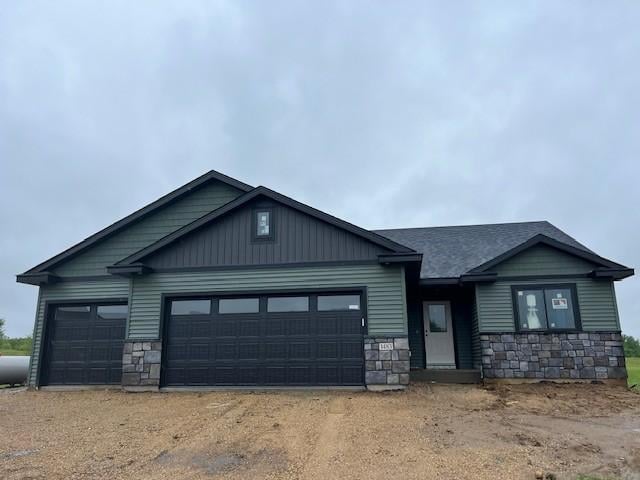 1483 Grand View Ln SE, Mazeppa, MN 55956 - craftsman-style house featuring stone siding, a garage, and dirt driveway