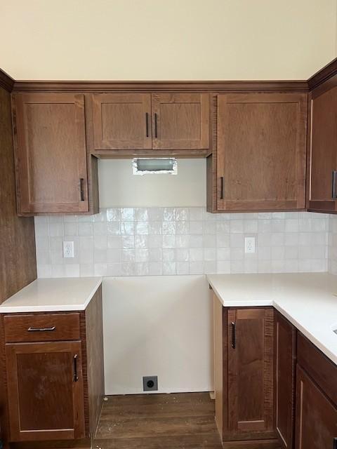 1483 Grand View Ln SE, Mazeppa, MN 55956 - kitchen with dark wood-style flooring, light countertops, and decorative backsplash