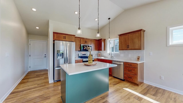1483 Grand View Ln SE, Mazeppa, MN 55956 - kitchen featuring stainless steel appliances, light wood-type flooring, a center island, hanging light fixtures, and lofted ceiling