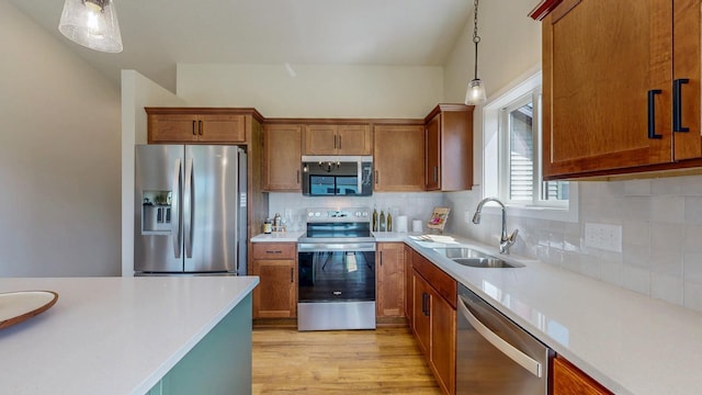 1483 Grand View Ln SE, Mazeppa, MN 55956 - kitchen with appliances with stainless steel finishes, decorative light fixtures, brown cabinetry, and light countertops