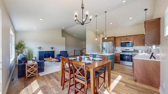 1483 Grand View Ln SE, Mazeppa, MN 55956 - dining room featuring light wood-style flooring, a chandelier, vaulted ceiling, and recessed lighting