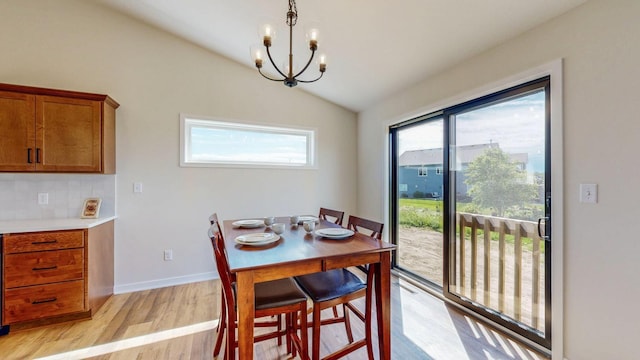 1483 Grand View Ln SE, Mazeppa, MN 55956 - dining space with a chandelier, vaulted ceiling, and light wood finished floors