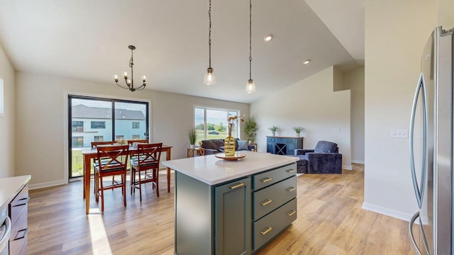 1483 Grand View Ln SE, Mazeppa, MN 55956 - kitchen featuring freestanding refrigerator, light countertops, a center island, light wood-type flooring, and a chandelier