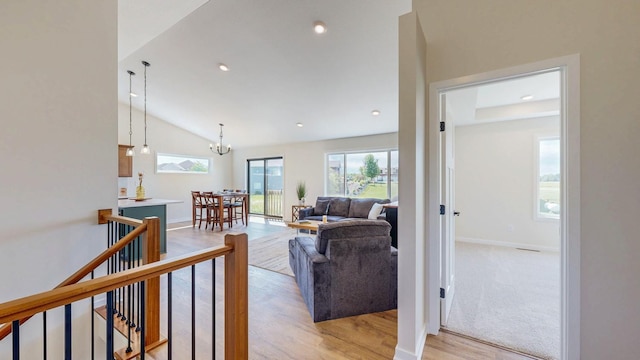 1483 Grand View Ln SE, Mazeppa, MN 55956 - living room with lofted ceiling, light wood finished floors, a chandelier, and recessed lighting
