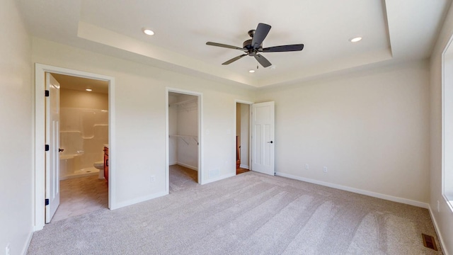 1483 Grand View Ln SE, Mazeppa, MN 55956 - unfurnished bedroom with light colored carpet, a raised ceiling, a walk in closet, recessed lighting, and ensuite bathroom