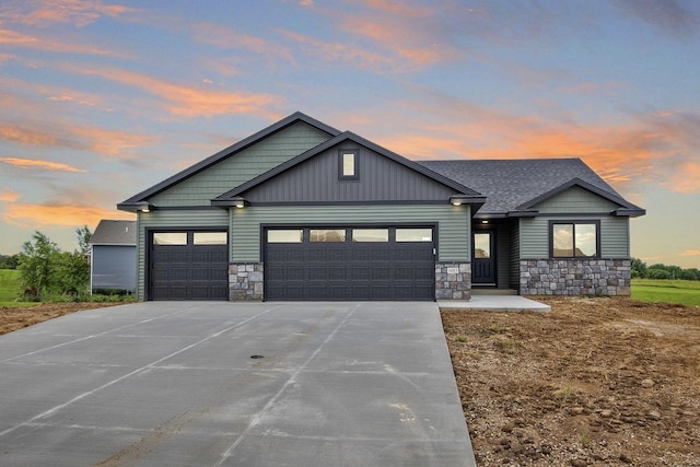 1483 Grand View Ln SE, Mazeppa, MN 55956 - view of front facade featuring stone siding, a garage, driveway, and roof with shingles