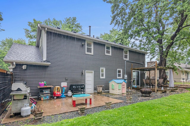 7912 Hillside Trl S, Cottage Grove, MN 55016 - rear view of property with an outdoor fire pit, a patio area, a yard, and a shingled roof