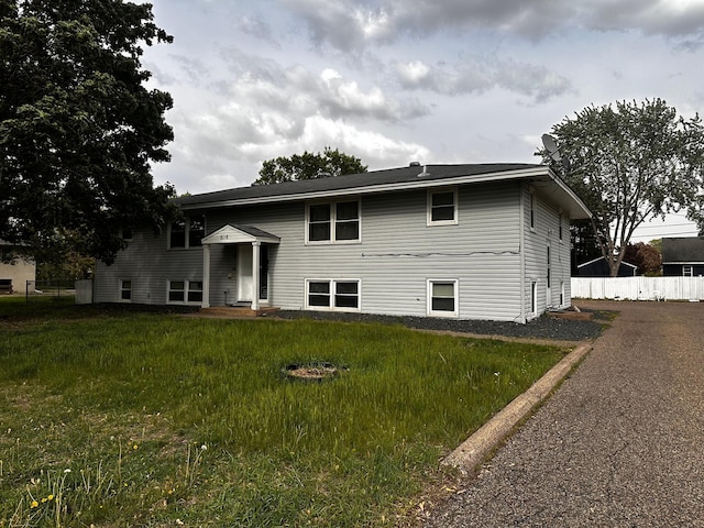 rear view of property featuring fence