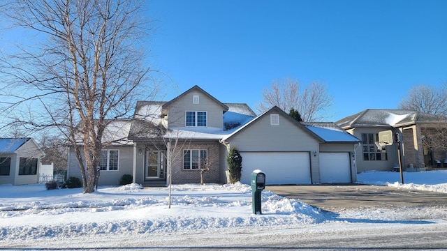 traditional home with a garage, driveway, and brick siding