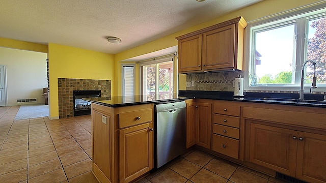 2714 Colleen St NE, Rochester, MN 55906 - kitchen with dishwasher, a sink, tile patterned flooring, open floor plan, and dark countertops