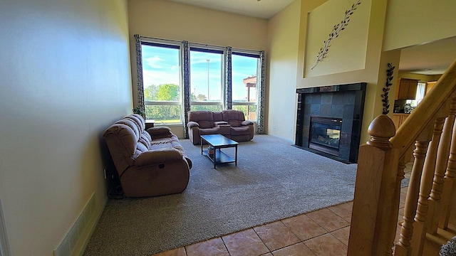 2714 Colleen St NE, Rochester, MN 55906 - living room featuring light carpet, a tiled fireplace, and light tile patterned floors
