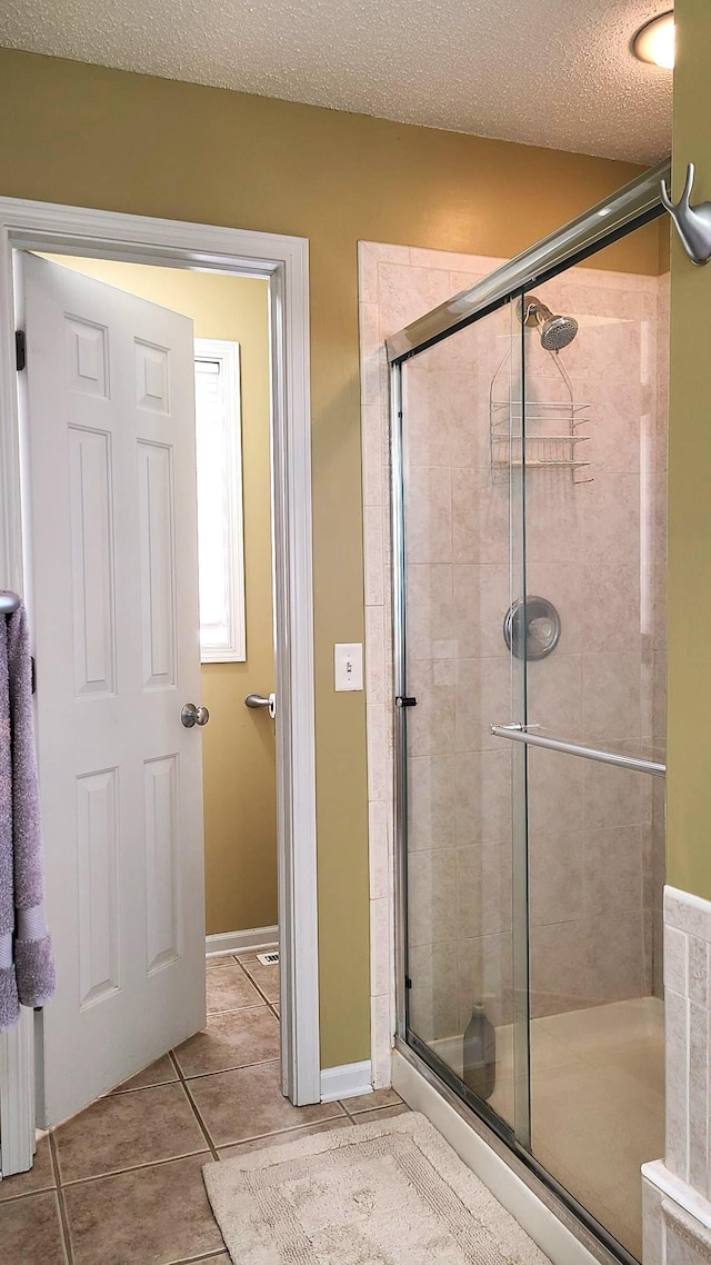 2714 Colleen St NE, Rochester, MN 55906 - bathroom featuring a stall shower, tile patterned floors, and a textured ceiling