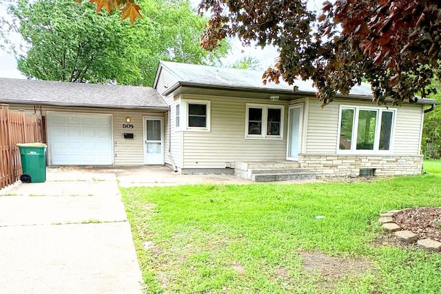 view of front of house with concrete driveway, a garage, and a front yard