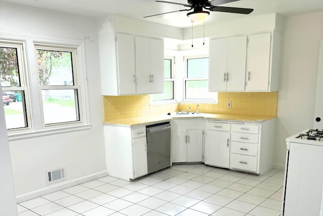kitchen with stainless steel dishwasher, light countertops, a ceiling fan, white gas stove, and tasteful backsplash