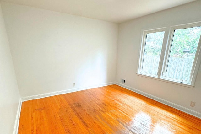 unfurnished room featuring light wood-style floors and baseboards