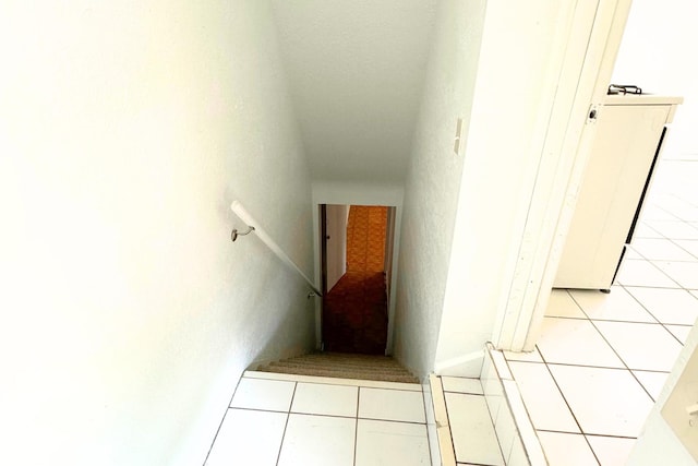 stairs featuring tile patterned flooring