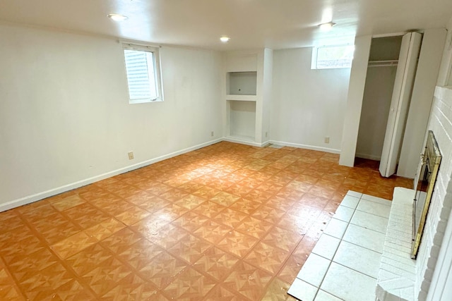 below grade area featuring healthy amount of natural light, a fireplace, and recessed lighting