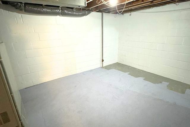 unfinished below grade area featuring concrete block wall