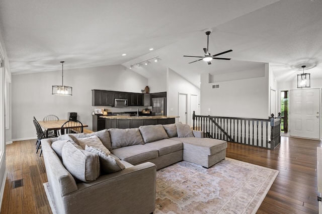4756 121st Ave NE, Blaine, MN 55449 - living room with a ceiling fan, dark wood-type flooring, baseboards, a chandelier, and high vaulted ceiling