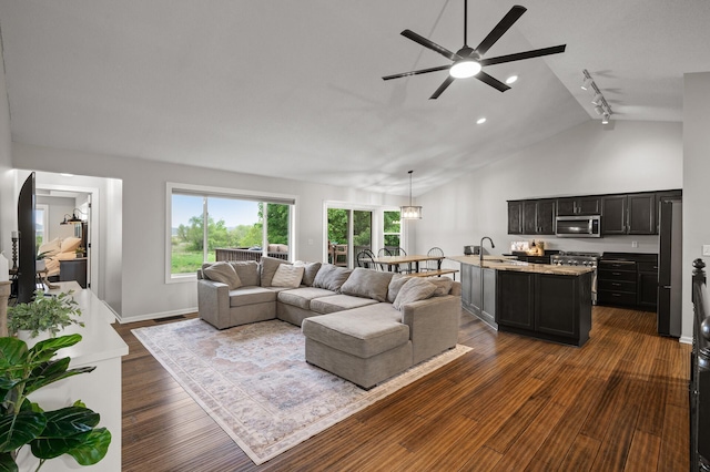 4756 121st Ave NE, Blaine, MN 55449 - living area featuring vaulted ceiling, a ceiling fan, dark wood-type flooring, and baseboards