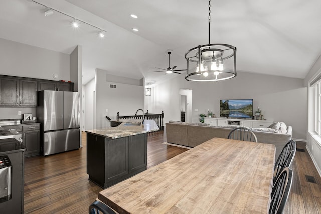 4756 121st Ave NE, Blaine, MN 55449 - kitchen with freestanding refrigerator, track lighting, open floor plan, ceiling fan, and high vaulted ceiling