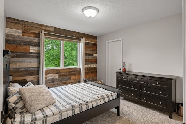 4756 121st Ave NE, Blaine, MN 55449 - bedroom featuring wood walls, light colored carpet, and a textured ceiling