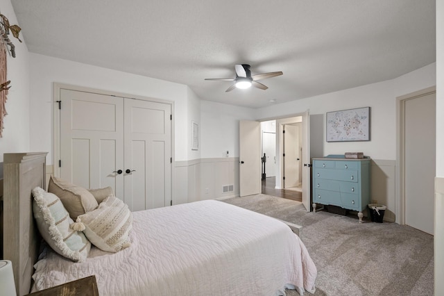 4756 121st Ave NE, Blaine, MN 55449 - carpeted bedroom featuring a ceiling fan, a closet, and a wainscoted wall