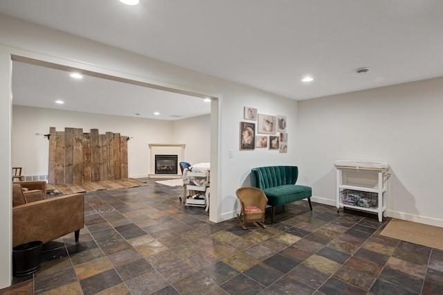 4756 121st Ave NE, Blaine, MN 55449 - sitting room featuring recessed lighting, baseboards, stone tile flooring, and a glass covered fireplace