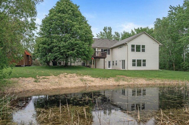 4756 121st Ave NE, Blaine, MN 55449 - back of house with a lawn, a deck with water view, and roof with shingles