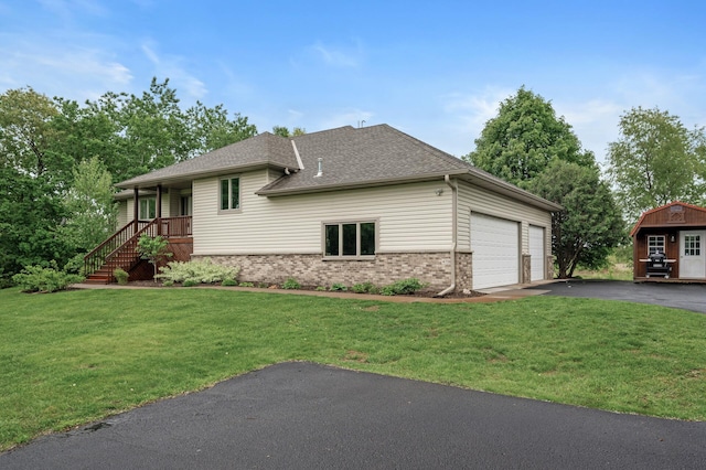 4756 121st Ave NE, Blaine, MN 55449 - view of front of property featuring brick siding, a front lawn, a garage, and roof with shingles