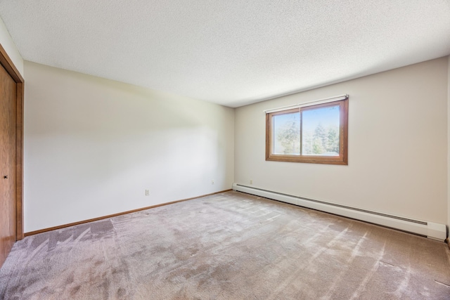 999 41st Ave NE Unit 110Ne, Columbia Heights, MN 55421 - empty room with a baseboard heating unit, carpet, a textured ceiling, and baseboards