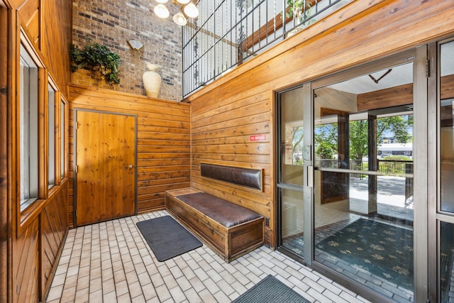 999 41st Ave NE Unit 110Ne, Columbia Heights, MN 55421 - entryway featuring a towering ceiling, wooden walls, brick patterned floors, and a chandelier