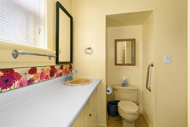 bathroom featuring toilet, vanity, and tile patterned flooring