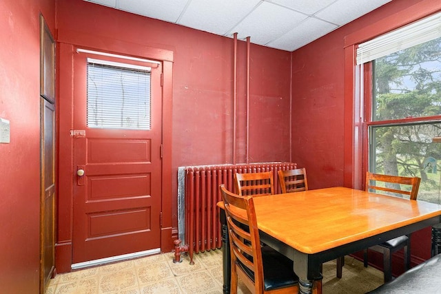dining space with a paneled ceiling