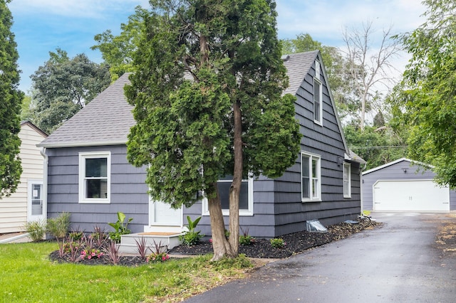 37 Harrison Ave S, Hopkins, MN 55343 - obstructed view of property with an outbuilding, a garage, roof with shingles, and asphalt driveway