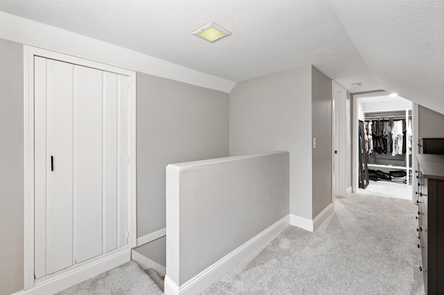 37 Harrison Ave S, Hopkins, MN 55343 - hallway featuring an upstairs landing, carpet, lofted ceiling, and a textured ceiling