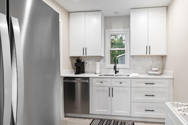 37 Harrison Ave S, Hopkins, MN 55343 - kitchen featuring stainless steel appliances, tasteful backsplash, light countertops, and white cabinetry