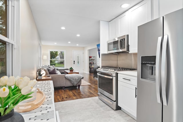 37 Harrison Ave S, Hopkins, MN 55343 - kitchen with appliances with stainless steel finishes, white cabinetry, open floor plan, recessed lighting, and light countertops