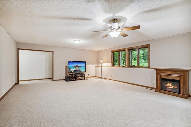 10791 3rd Street Pl N, Lake Elmo, MN 55042 - unfurnished living room featuring ceiling fan, carpet flooring, a glass covered fireplace, a textured ceiling, and baseboards