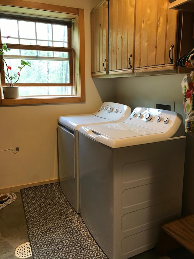 laundry area featuring cabinet space, washer and dryer, and baseboards