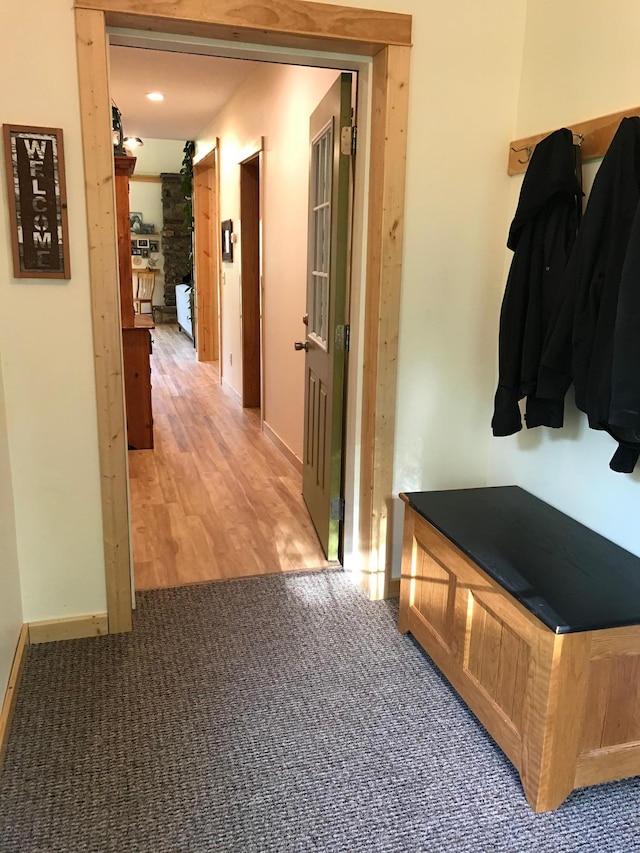 mudroom with light colored carpet and baseboards