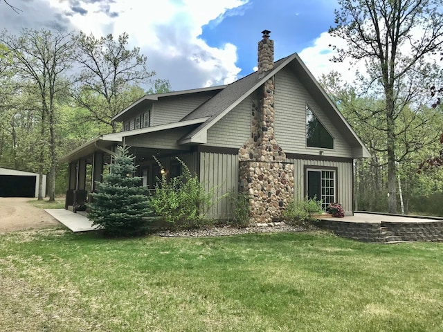 view of property exterior featuring a chimney, a lawn, and board and batten siding