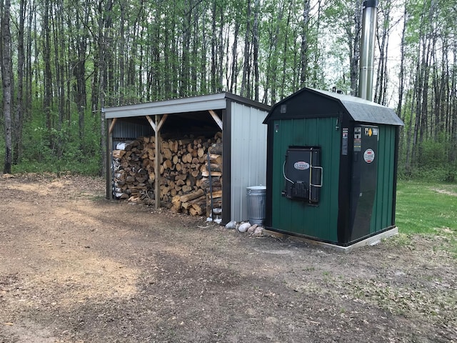 view of outbuilding featuring an outbuilding and a forest view