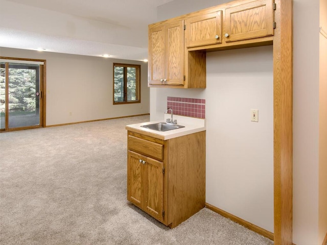 17768 Keystone Ave, Lakeville, MN 55044 - kitchen featuring a sink, light carpet, baseboards, and healthy amount of natural light