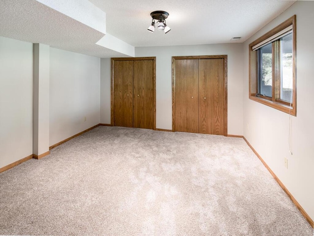 17768 Keystone Ave, Lakeville, MN 55044 - unfurnished bedroom featuring multiple closets, carpet flooring, and baseboards